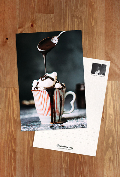 A striped cup with hot chocolate and marshmallows