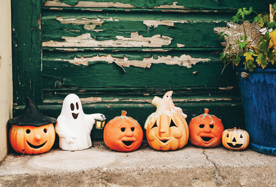 Little ghost and smiling pumpkins
